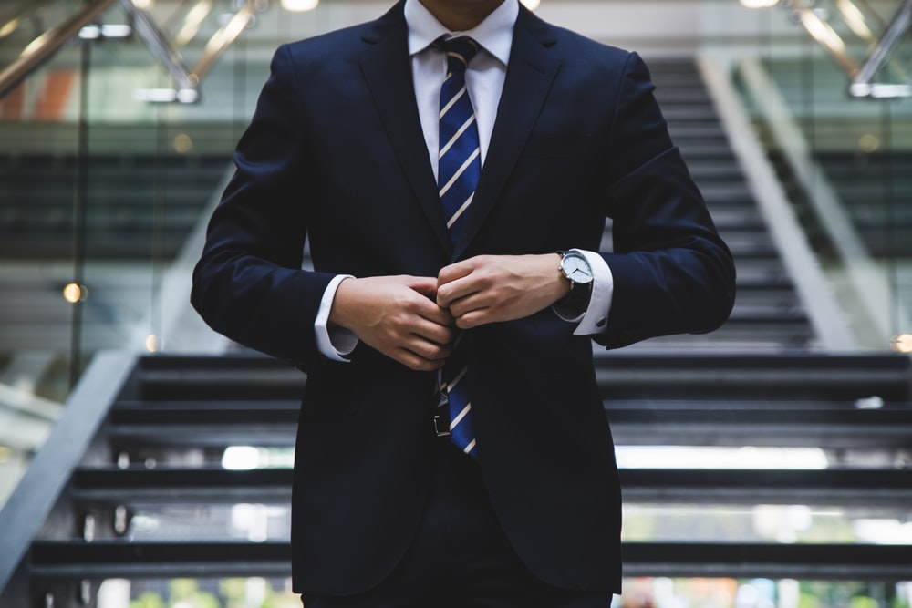 businessman buttoning his coat