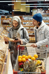 A couple shopping together in the bakery section of a supermarket.