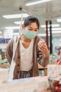 A shopper examining a food product closely in a grocery aisle