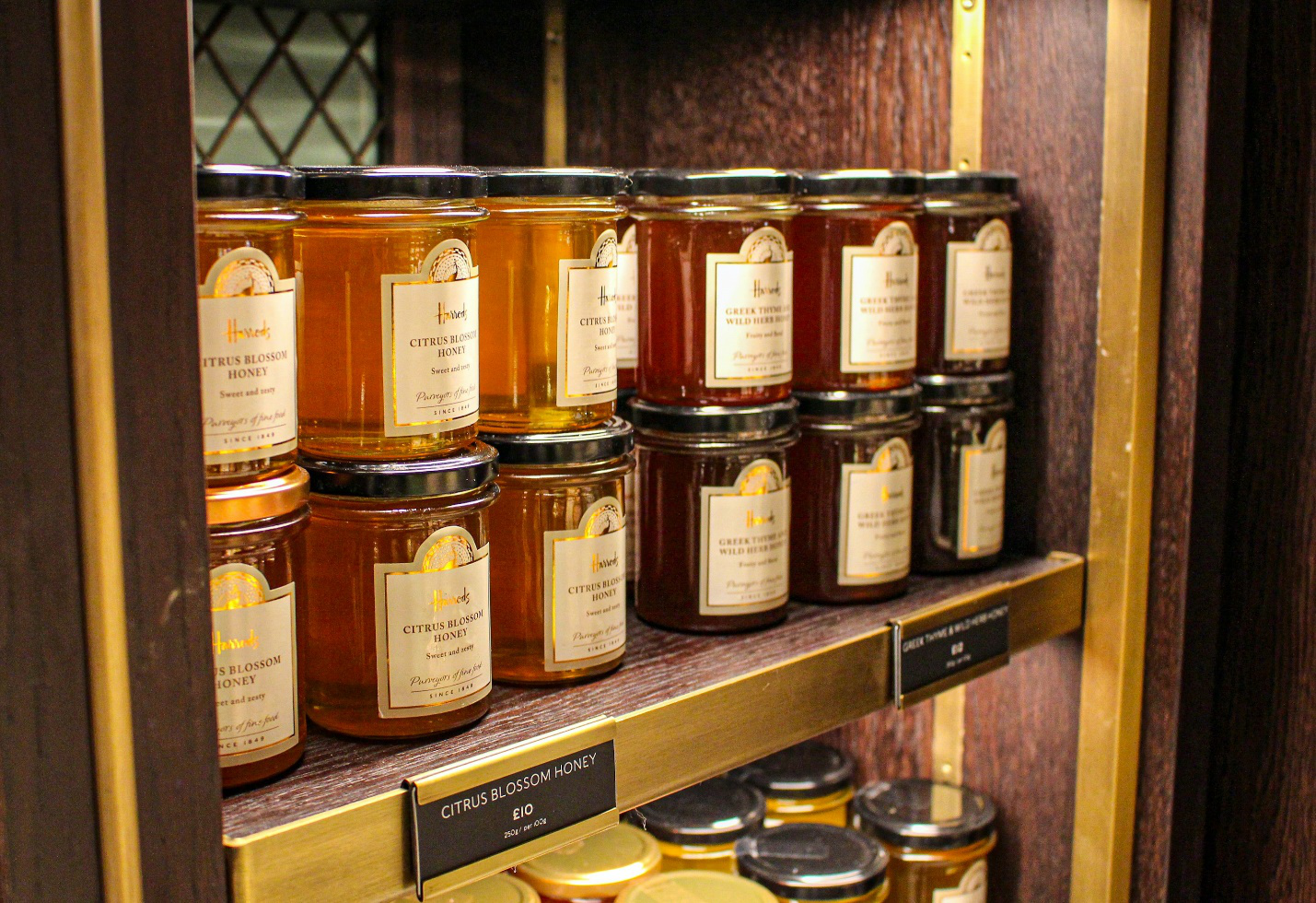 Jars of honey on a wooden shelf