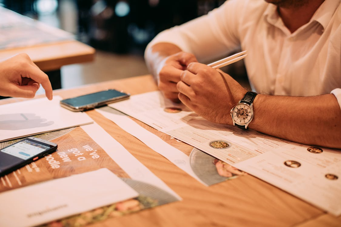 Restaurant-menu A person sitting at a restaurant with a menu