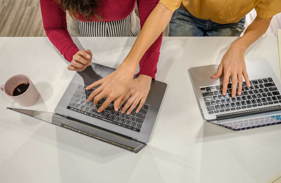 An image of CPG consultants typing on laptops 