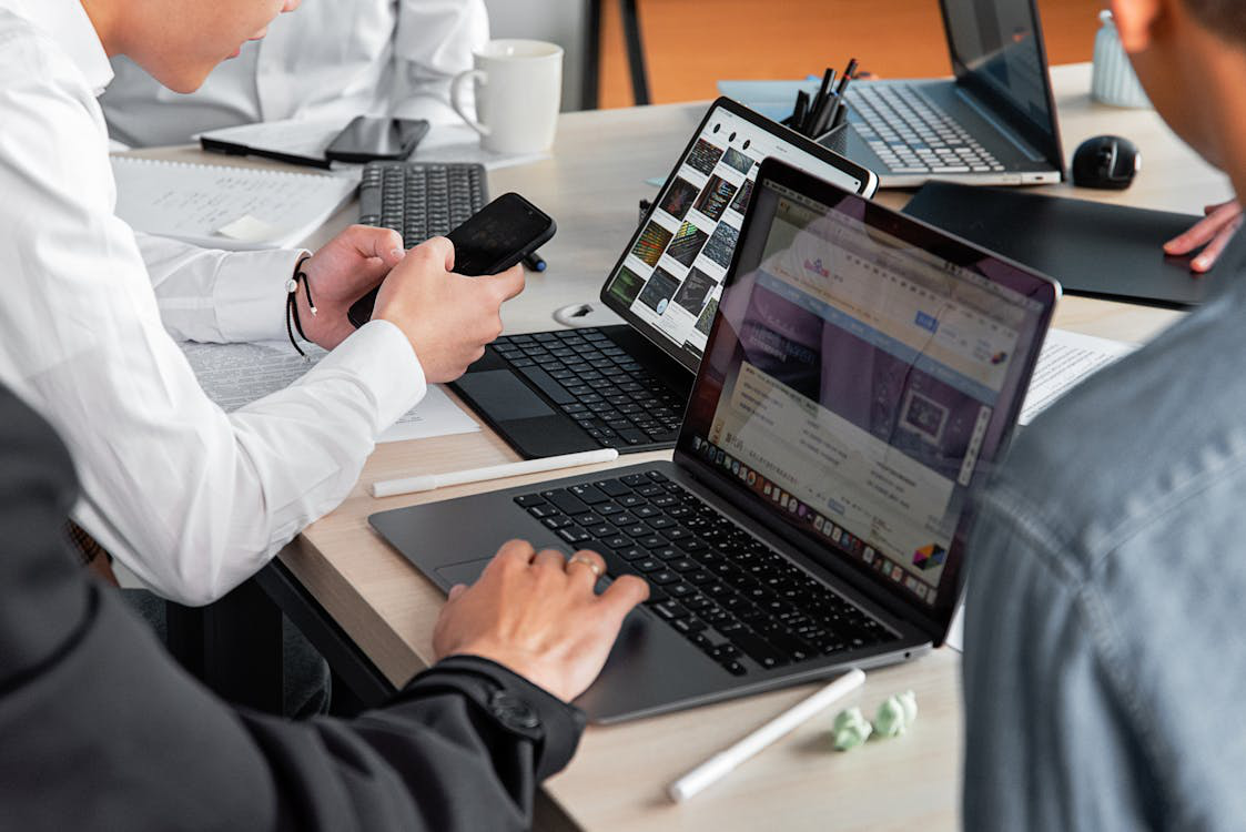 An image of CPG consultants working on laptops    