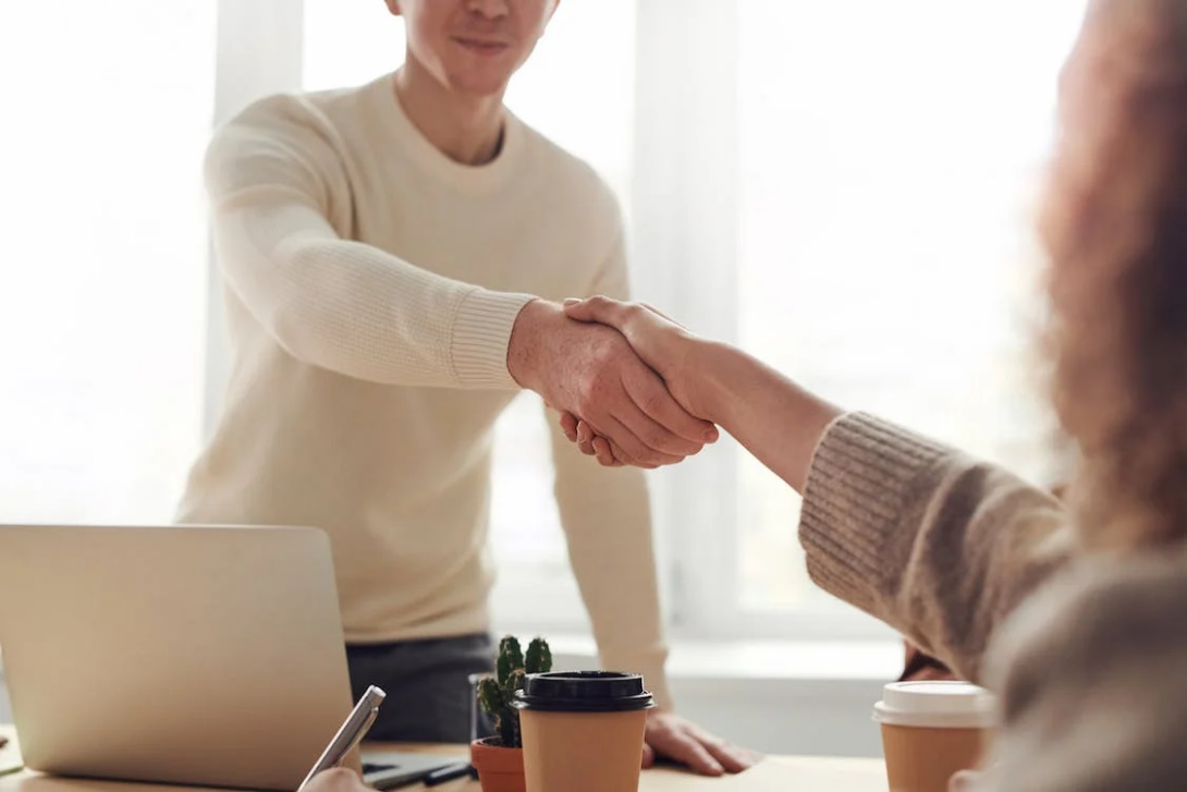 An image of a man and woman shaking hands