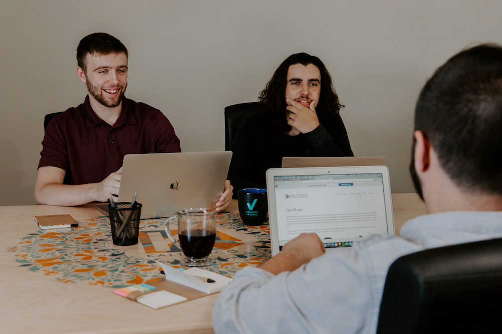Three people working on laptops