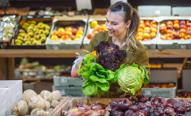 A woman browsing through the fresh produce, highlighting the importance of product placement in consumer purchasing decisions.