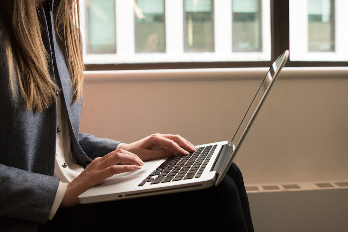 An image of a CPG consultant typing on a laptop